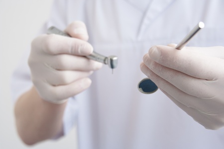 Closeup of dentist hand with drill and mirror.の写真素材