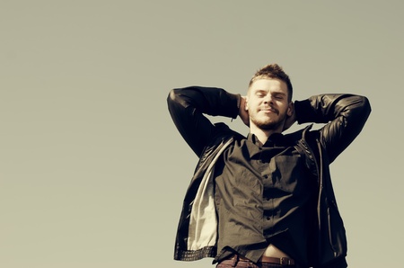 Portrait of a happy young male, sky background. Retro style.の写真素材