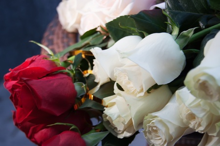 Bouquet with red and white roses on a table.の写真素材