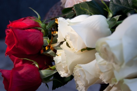 Bouquet with red and white roses on a table.の写真素材
