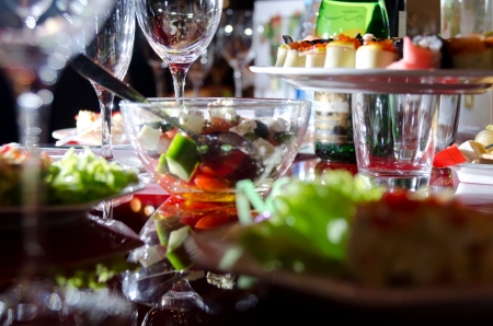 Served for a banquet table.  Greek salad, wine glasses.の写真素材