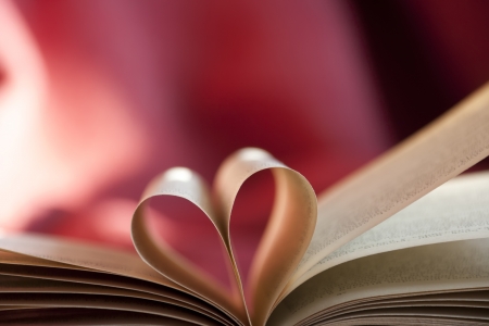 Pages of a book curved into a heart shape.の写真素材