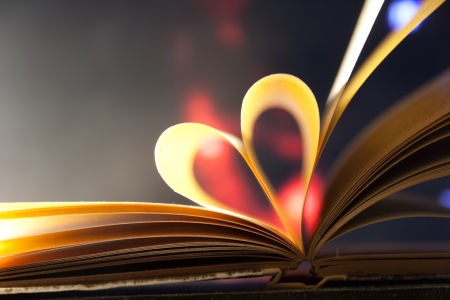 Pages of a book curved into a heart shape.の写真素材