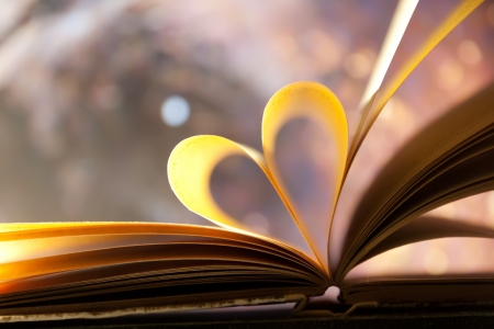 Pages of a book curved into a heart shape.の写真素材