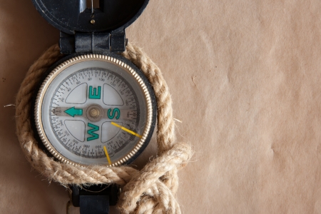 Old compass and rope on old paper background.の写真素材