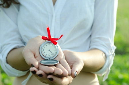 Girl Holding Old Fashioned Pocket Watch の写真素材