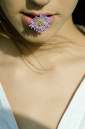 Girl with blue flower- Cornflower.の写真素材