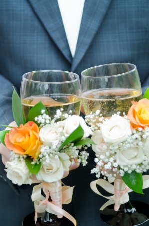 Wedding glasses with champagne in hands の写真素材