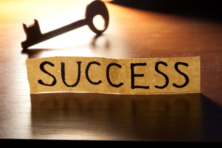 The Key to Success. Key on a wooden background.の写真素材