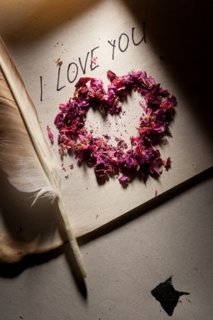 Valentine. 'I love you', heart on the old paper and feather pen.の写真素材