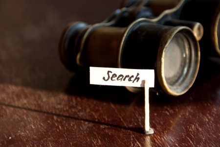 Search concept, old binoculars and an inscription searchの写真素材