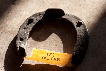 yes you can  inscription and  horseshoe over wooden backgroundの写真素材