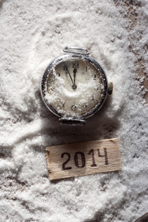 Watch lying in the snow before the new year and tag 2014の写真素材