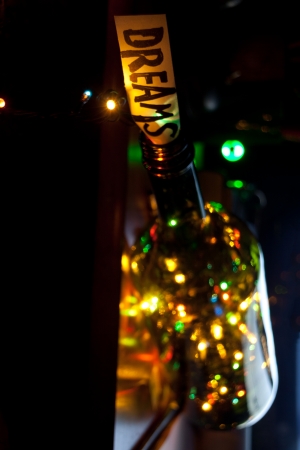 Dreams concept. The word dream, bottle and multicolored lightsの写真素材