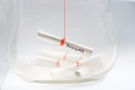 Dreams concept , Dreams written on a white rolled paper in a glass jarの写真素材