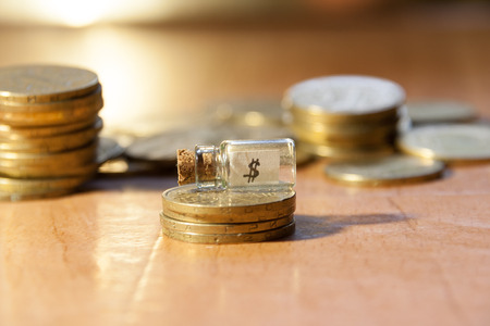 Finance & banking concept, dollar sign, gold coins and glass jar.の写真素材