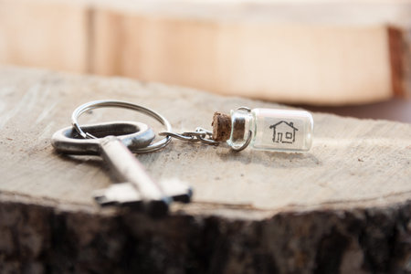 Real Estate concept, drawing of a house in a glass bottle and key.の写真素材