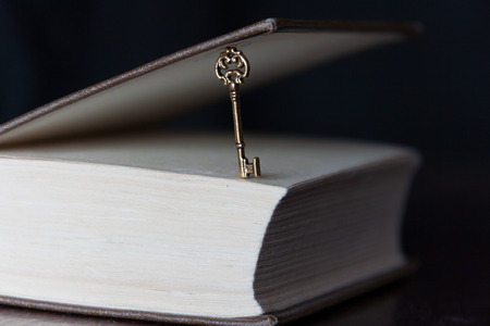 golden key and a book, education is the key conceptの写真素材