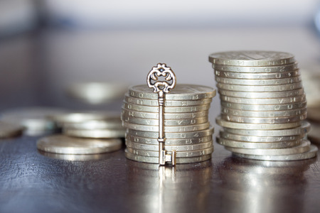 golden coins with golden key, key to money, business financial success conceptの写真素材
