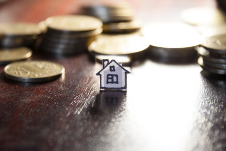 real estate loan concept, money for home, gold coins and houseの写真素材