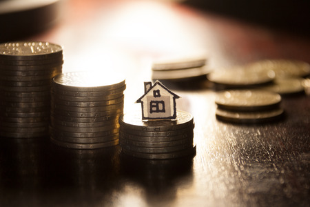 real estate loan concept, money for home, gold coins and houseの写真素材