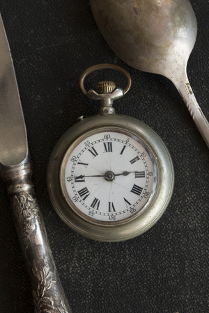 Vintage spoon, knife and pocket watches. Time for dinner.の写真素材