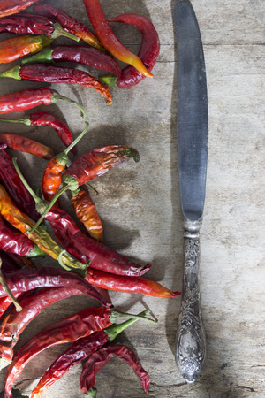 Hot red chili or chilli pepper and knifeの写真素材