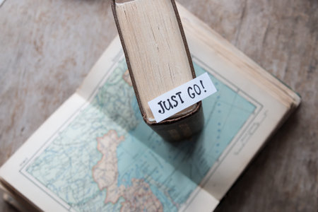 text Just go book and map. Travel and tourism concept.