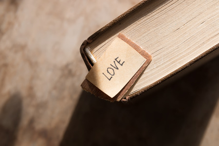 love story concept. label Love and book on the wooden background.の写真素材