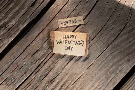 Happy Valentine's Day Hand Lettering, label on a wooden tableの写真素材