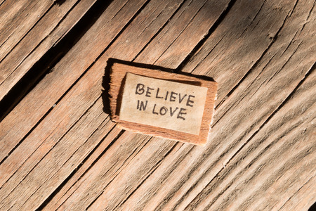 Believe in love concept. label on the wooden background.の写真素材