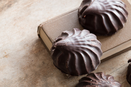 chocolate covered marshmallows on a wooden tableの写真素材
