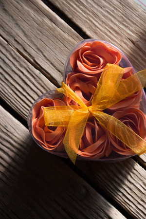 roses on March 8 in a box in the shape of heart on the wooden background.の写真素材