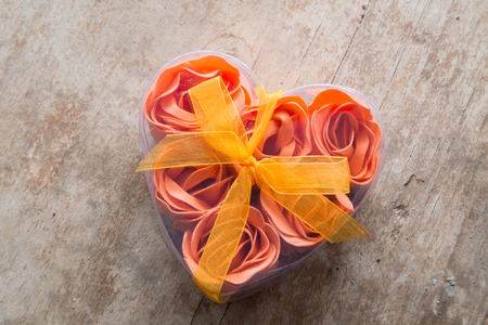 roses on March 8 in a box in the shape of heart on the wooden background.の写真素材