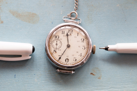 Retro background, old watches and pen on a blue background, vintage.の写真素材