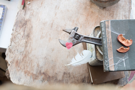 Fathers Day background. Vintage metal adjustable wrench and paper heart on a wooden table with copy space. Happy fathers day card.の写真素材