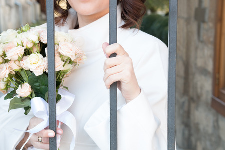 bride with flowers behind barsの写真素材