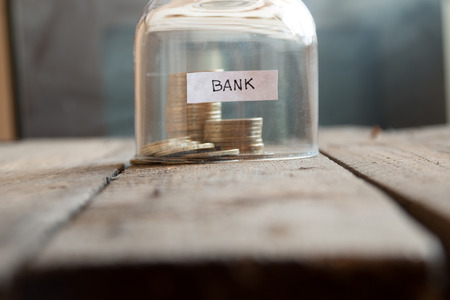 Bank Concept. Gold coins on a table under a glass cover.の写真素材