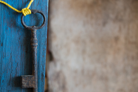 old key on blue wooden table, space for textの写真素材