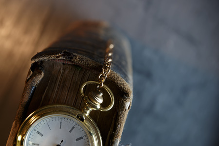 Vintage pocket watch and old book, symbols of time with copy spaceの写真素材