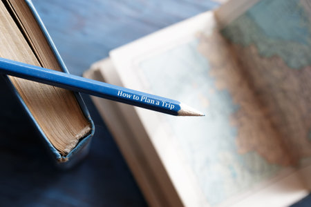 How to Plan a Trip. Pencil, book and old maps.