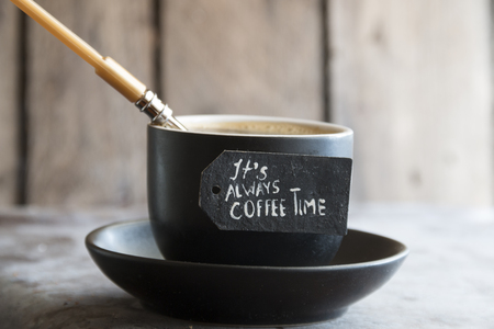 spoon and a cup of coffee and tag "it always coffee time"の写真素材