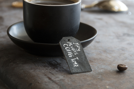 spoon and a cup of coffee and tag "it always coffee time"の写真素材