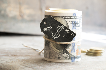 Dollar roll, tag with a dollar sign and golden coinsの写真素材