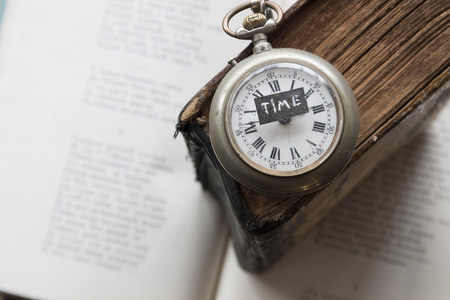 time text and old pocket watch on the book, education, study, exam ideaの写真素材