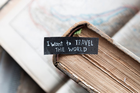 "i want to travel the world"  inscription on the label, old books and mapsの写真素材