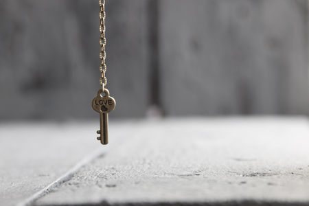 key with  heart and text Love on dark wooden background, close upの写真素材