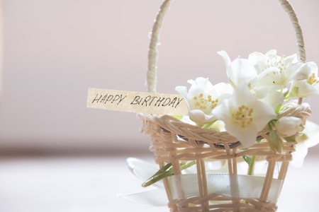 happy birthday letter tag or label a basket of flowersの写真素材