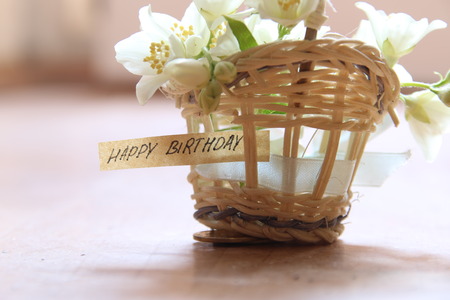 happy birthday letter tag or label a basket of flowersの写真素材