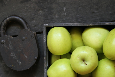 green apples on a black wooden backgroundの写真素材